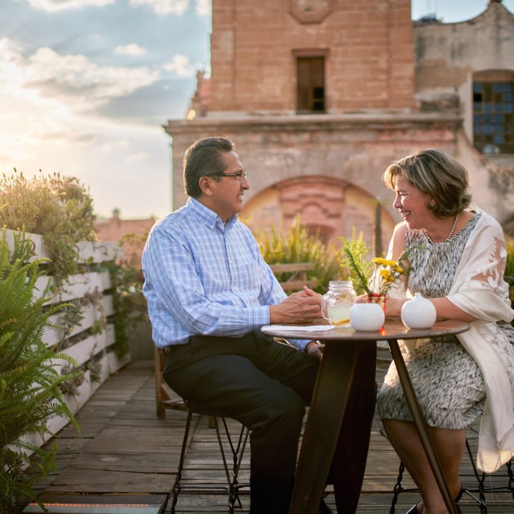 Senior couple on a date on an outdoor restaurant, having a conversation