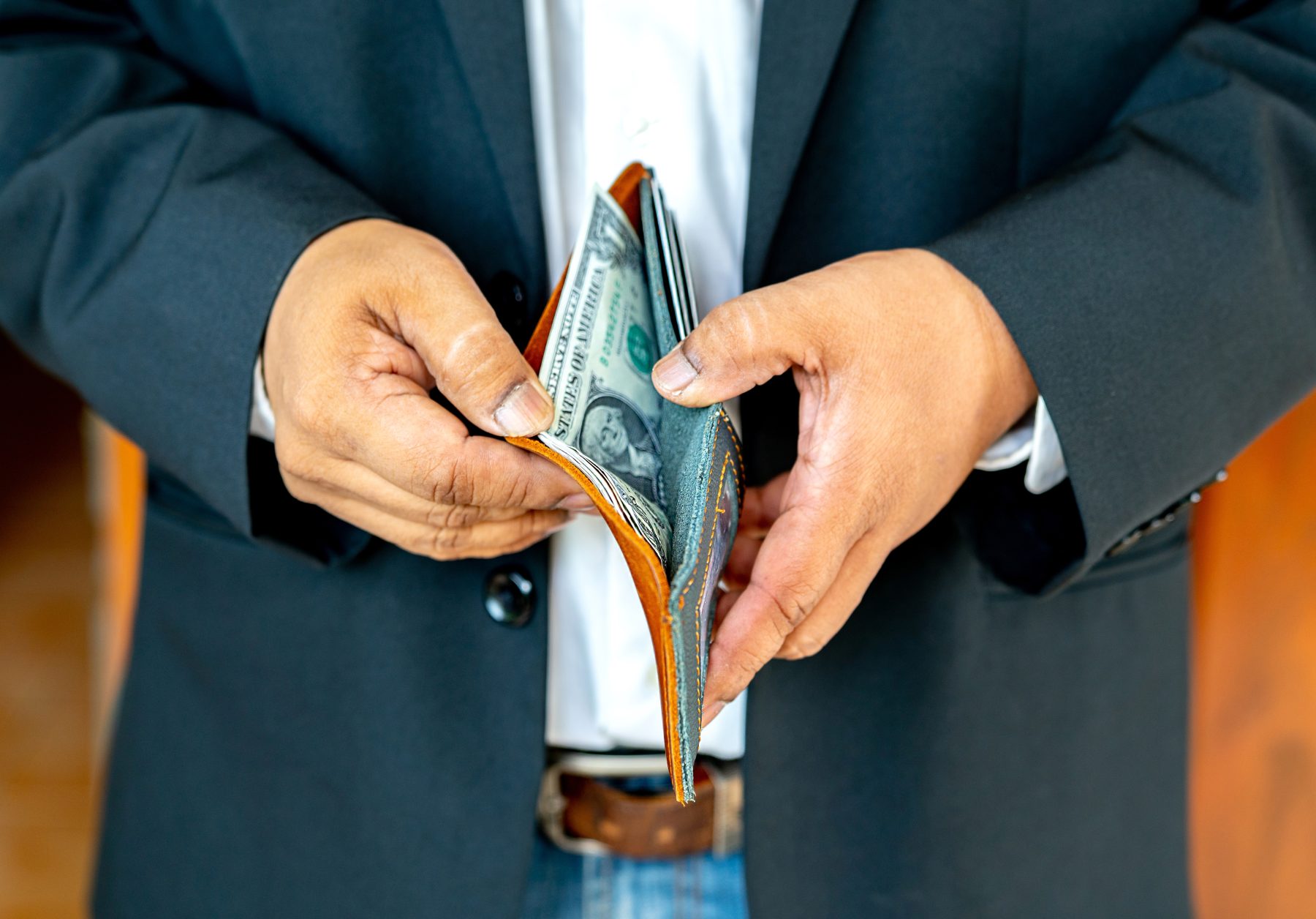 A closeup of hands holding open a wallet