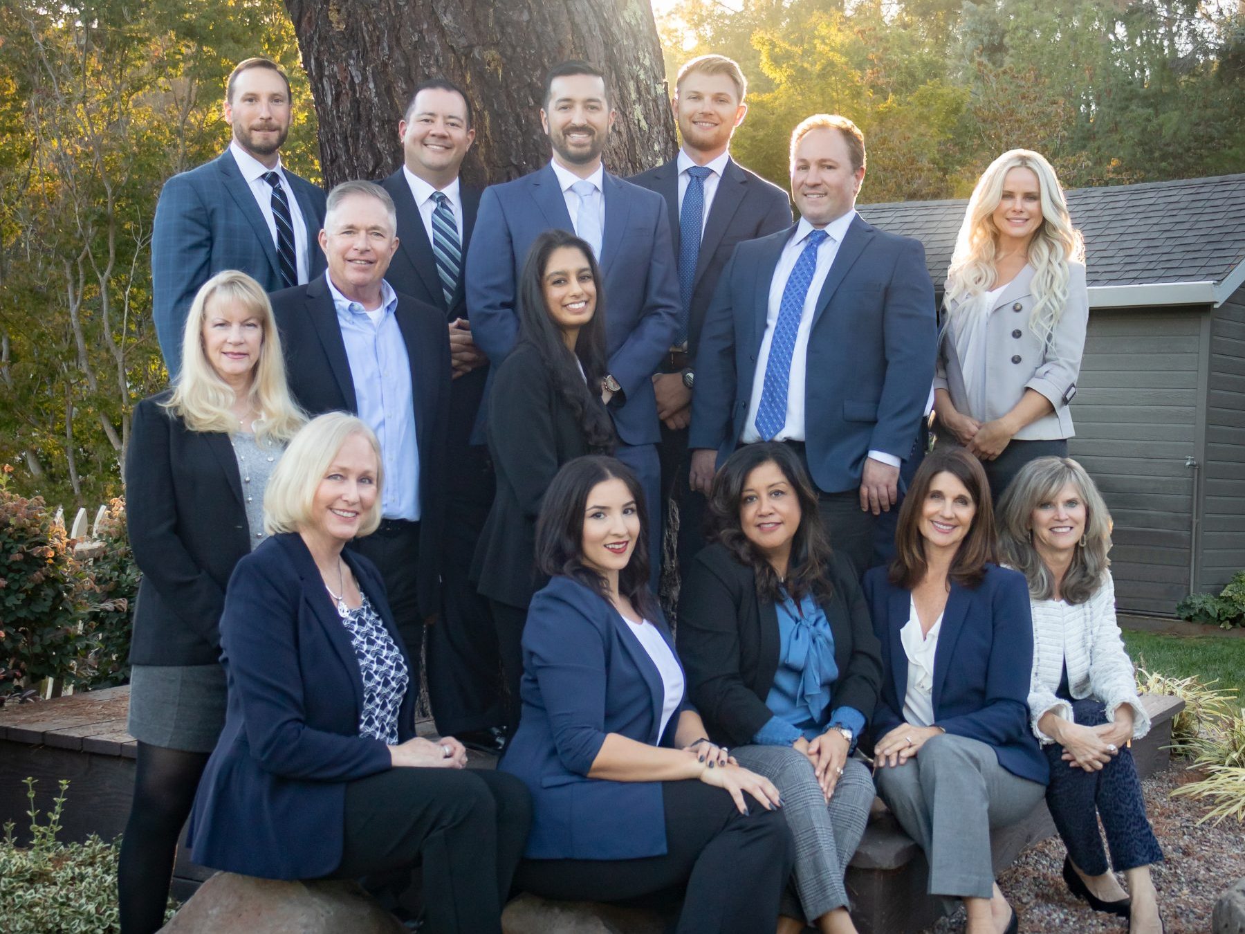 Staff from Capital Advantage pose for a group image sitting in front of a tree